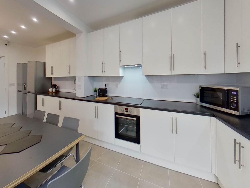 A modern, well-maintained kitchen featuring sle...