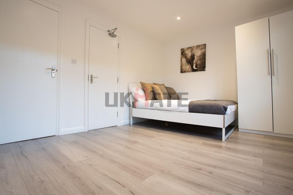 Bright and tidy student room featuring a single...