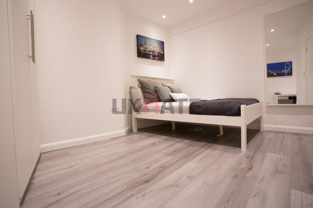 Bright and modern single bedroom featuring a co...