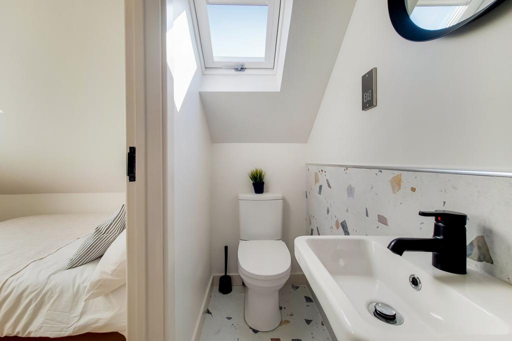 Bright and tidy bathroom featuring a toilet, sm...