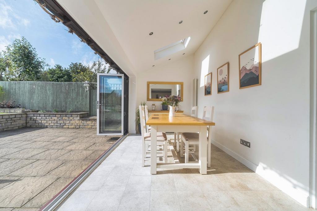 Bright dining area with folding doors onto the...