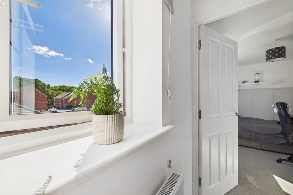 A window floods the landing with natural light