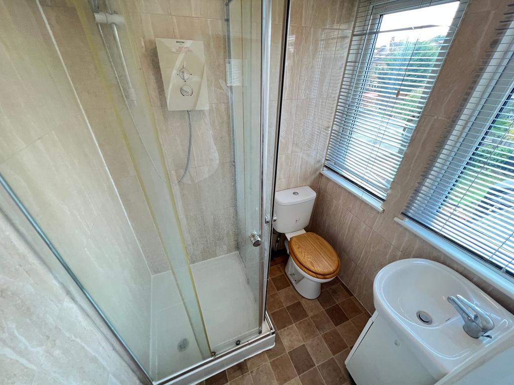 Bright bathroom featuring a modern shower cubic...
