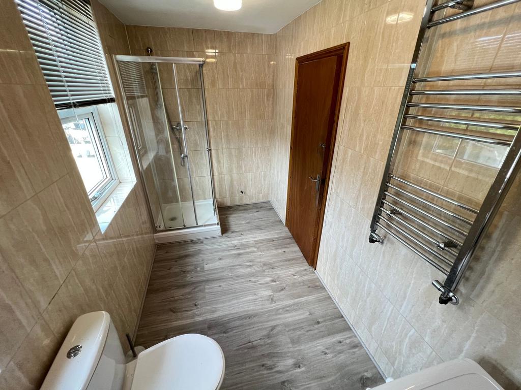 A clean, modern bathroom featuring a spacious s...