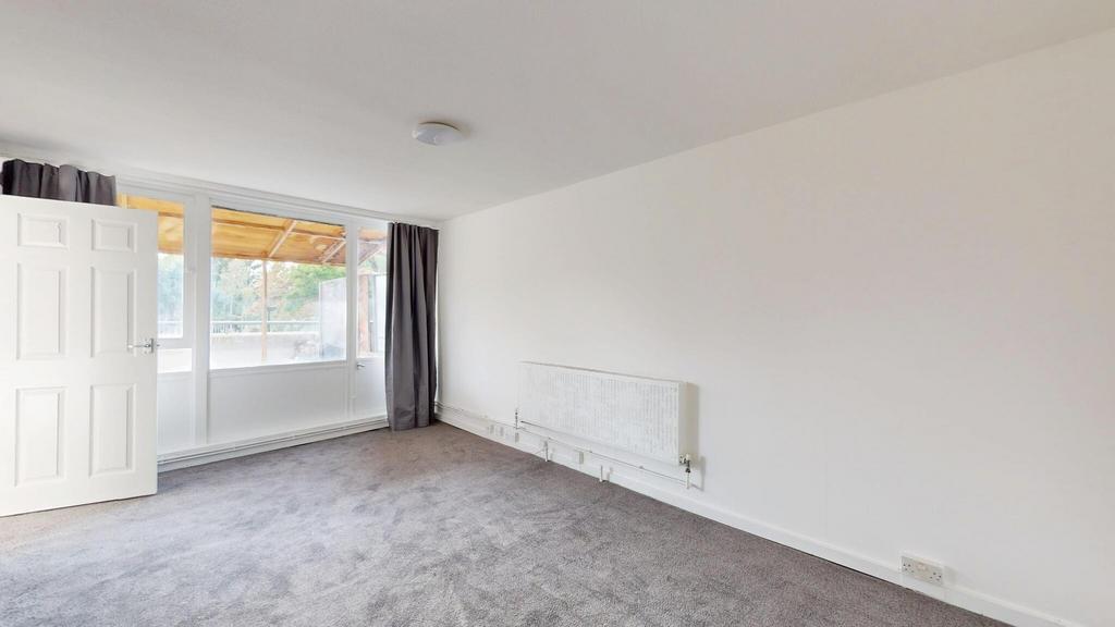 Bright and spacious living room with large wind...