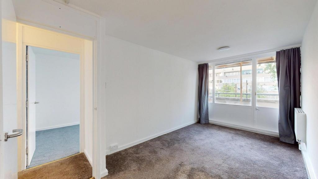 A spacious and bright living room with large wi...
