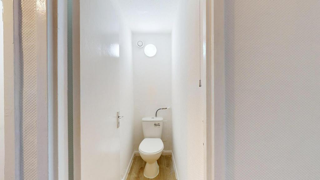 A clean, well-maintained bathroom with a white ...