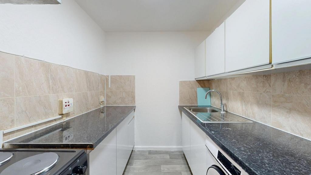 A modern, tidy kitchen with granite countertops...
