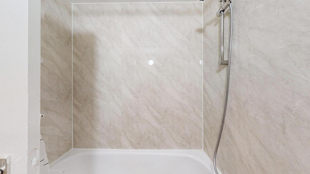 A modern bathroom with a large, clean shower ar...