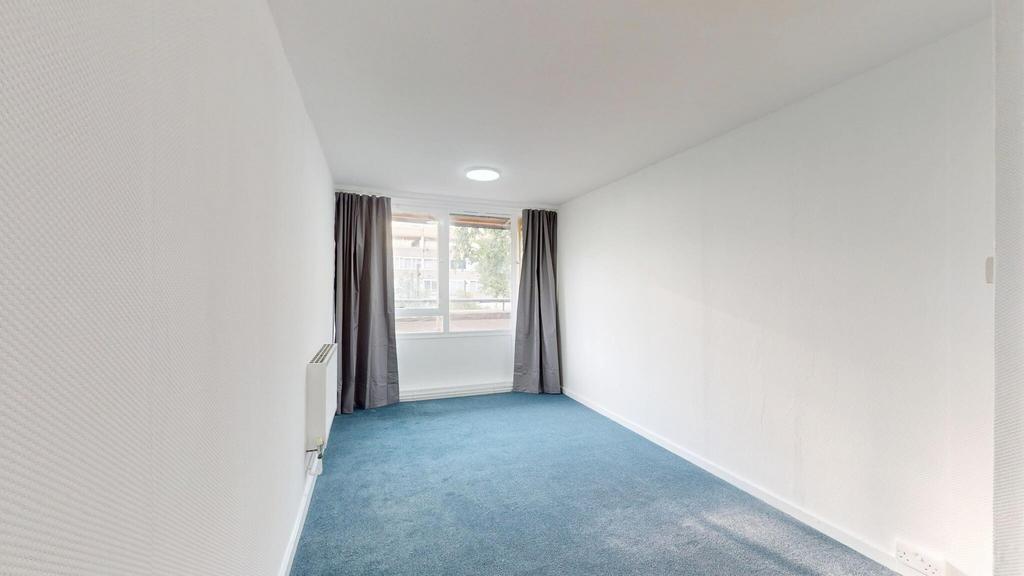 Bright and airy living room with a large window...