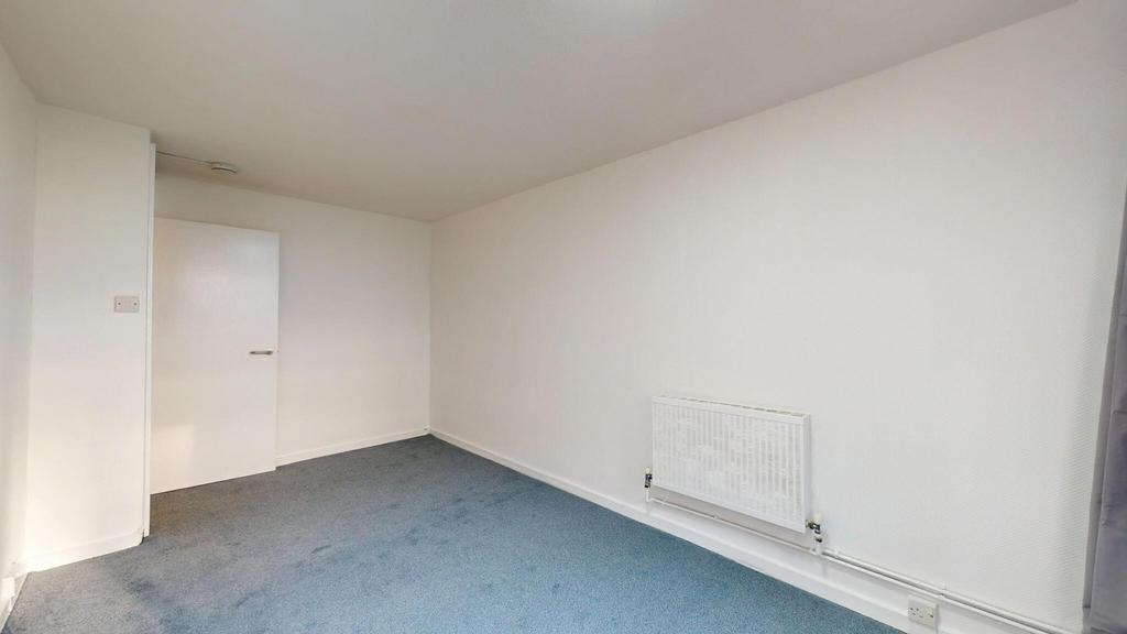 A clean, well-maintained room with neutral whit...