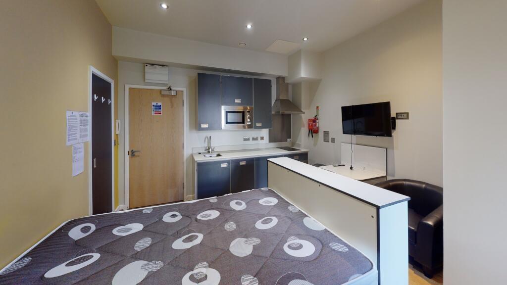 A well-maintained bedroom featuring a double be...