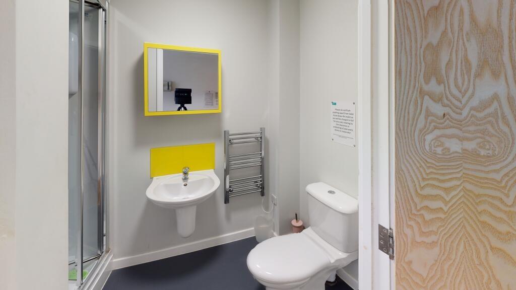 A modern bathroom featuring a toilet and a sink...