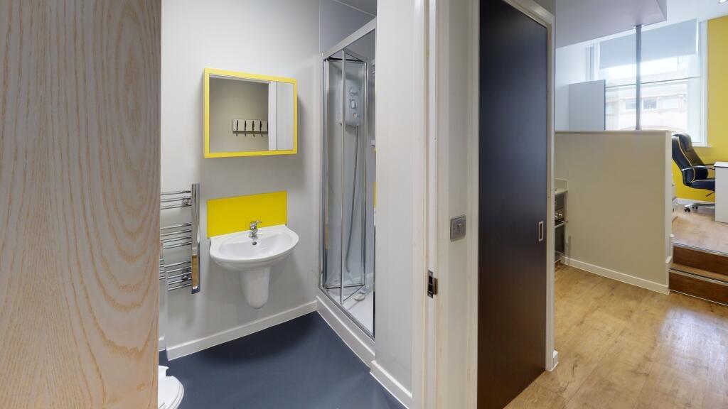 A bright and clean bathroom featuring a large s...