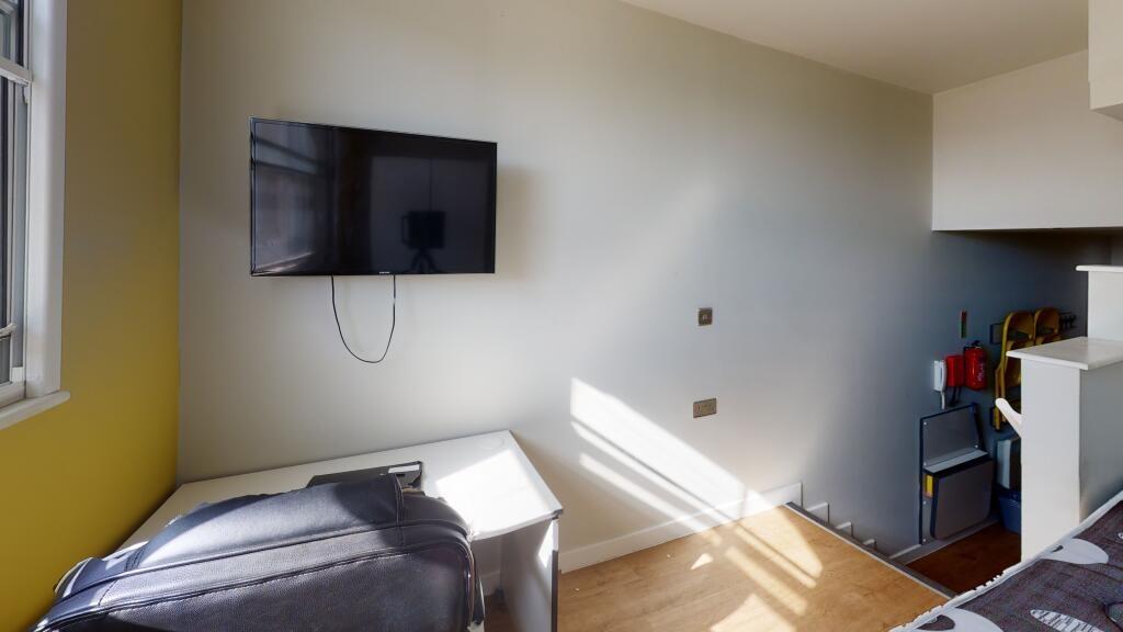 A clean and modern single toilet room with natu...