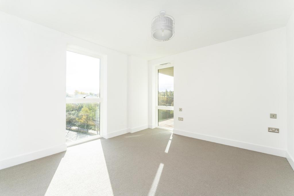 Bright and spacious master bedroom featuring la...