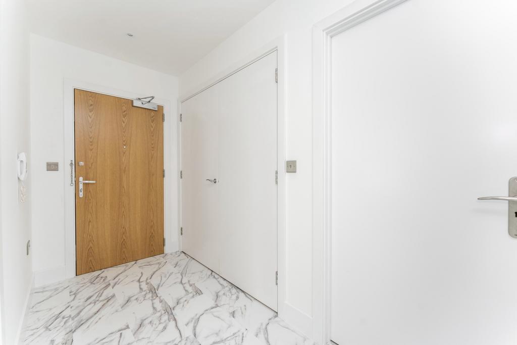 Bright and clean hallway featuring modern white...