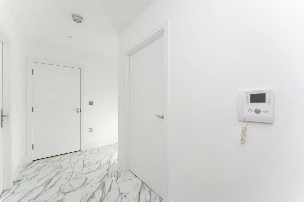 Bright and clean hallway featuring modern white...