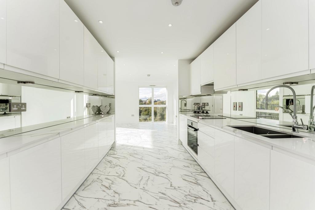 Bright and modern kitchen featuring sleek white...