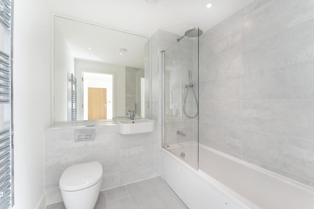 A modern bathroom suite featuring a sleek batht...