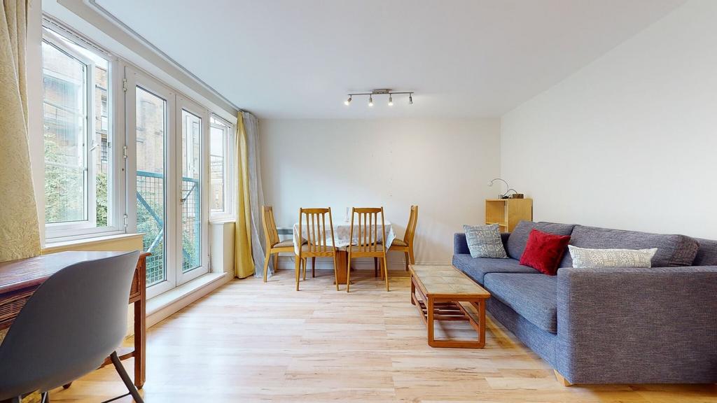 Bright and airy living room featuring large win...