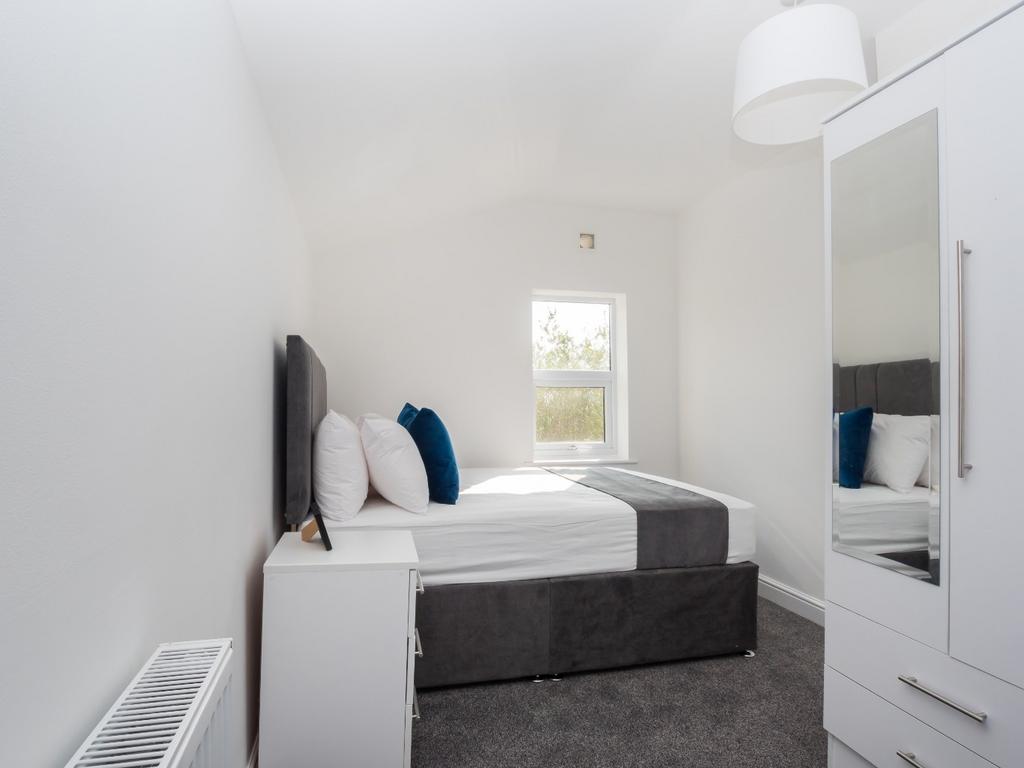 A bright and neat double bedroom featuring a co...