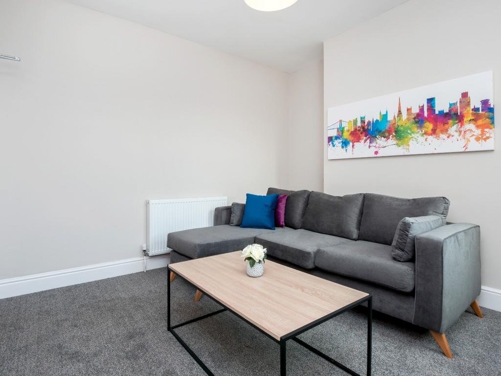 Bright lounge with modern grey sofa and coffee ...