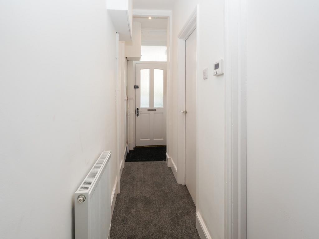 A clean and bright hallway with white walls and...