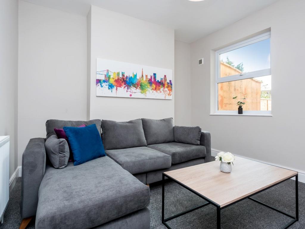 Bright and modern living room featuring a large...