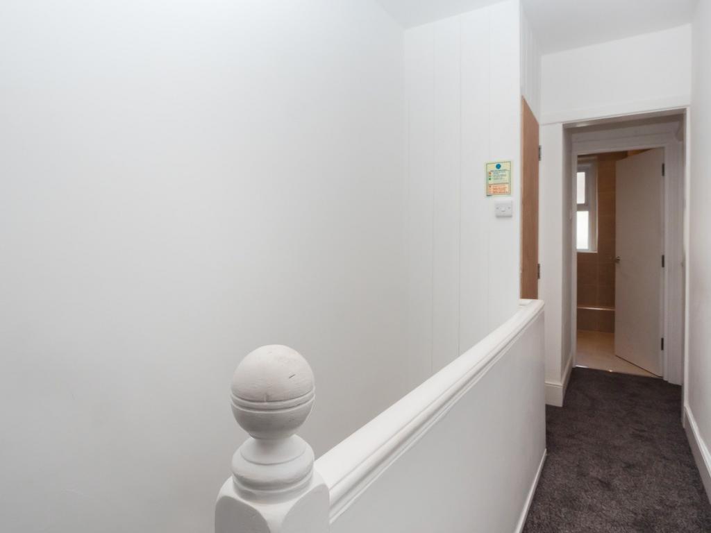 Bright, neutral upstairs landing with carpet...