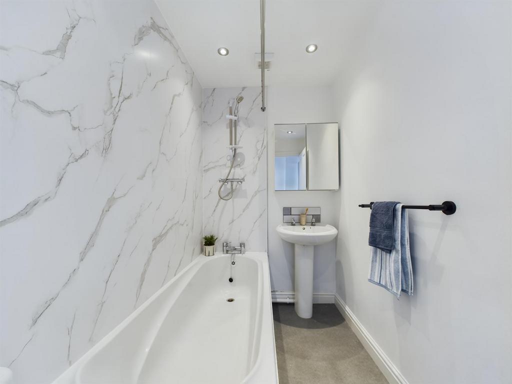 A bright and modern bathroom with clean white m...