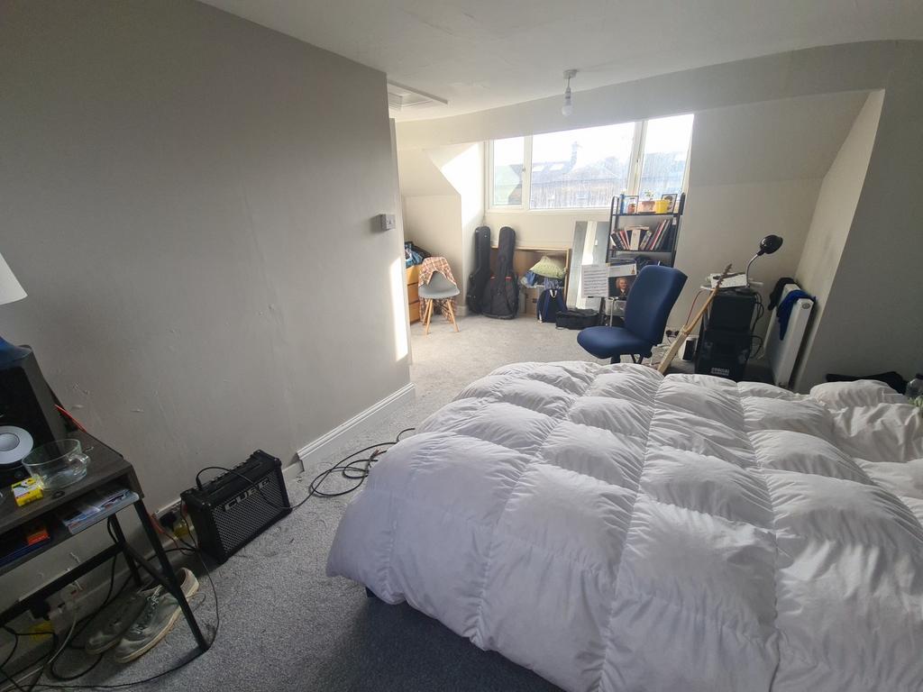 Bright and spacious master bedroom featuring a ...