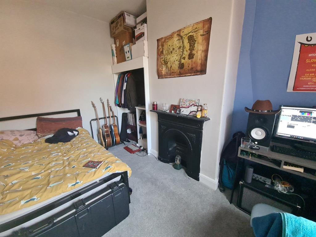 A cozy master bedroom featuring a double bed, a...