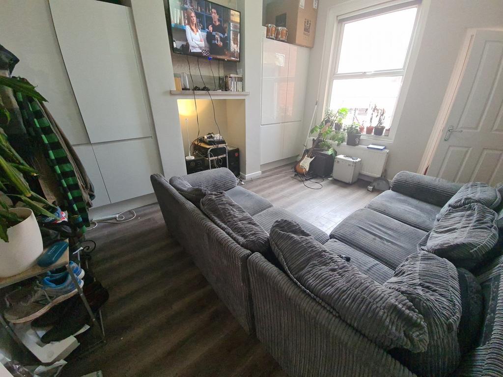 A cozy living room featuring a large comfortabl...