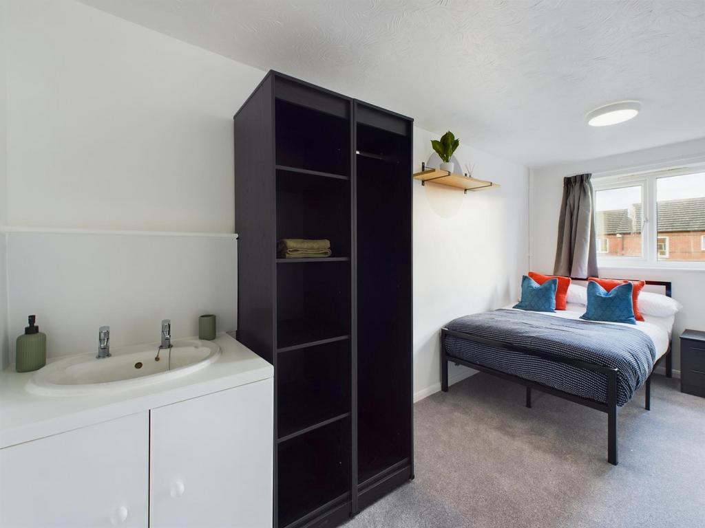 A bright and inviting double bedroom featuring ...