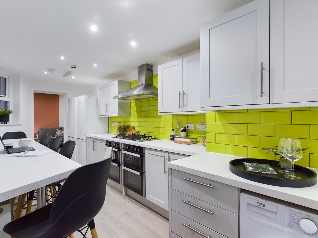 A stylish and modern kitchen featuring vibrant ...