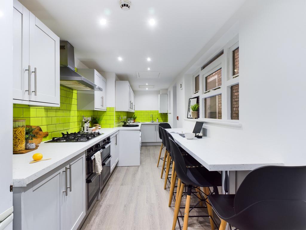 A modern and spacious kitchen with bright green...