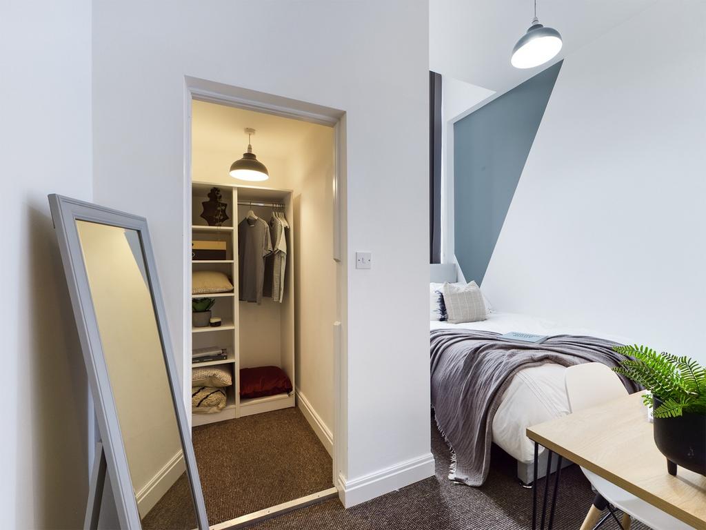 A stylish and well-lit double bedroom with a fi...