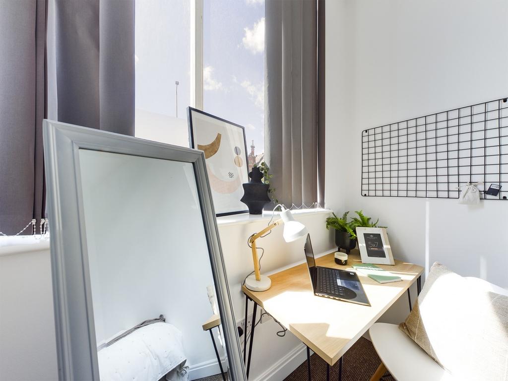 A bright and inviting communal workspace featur...