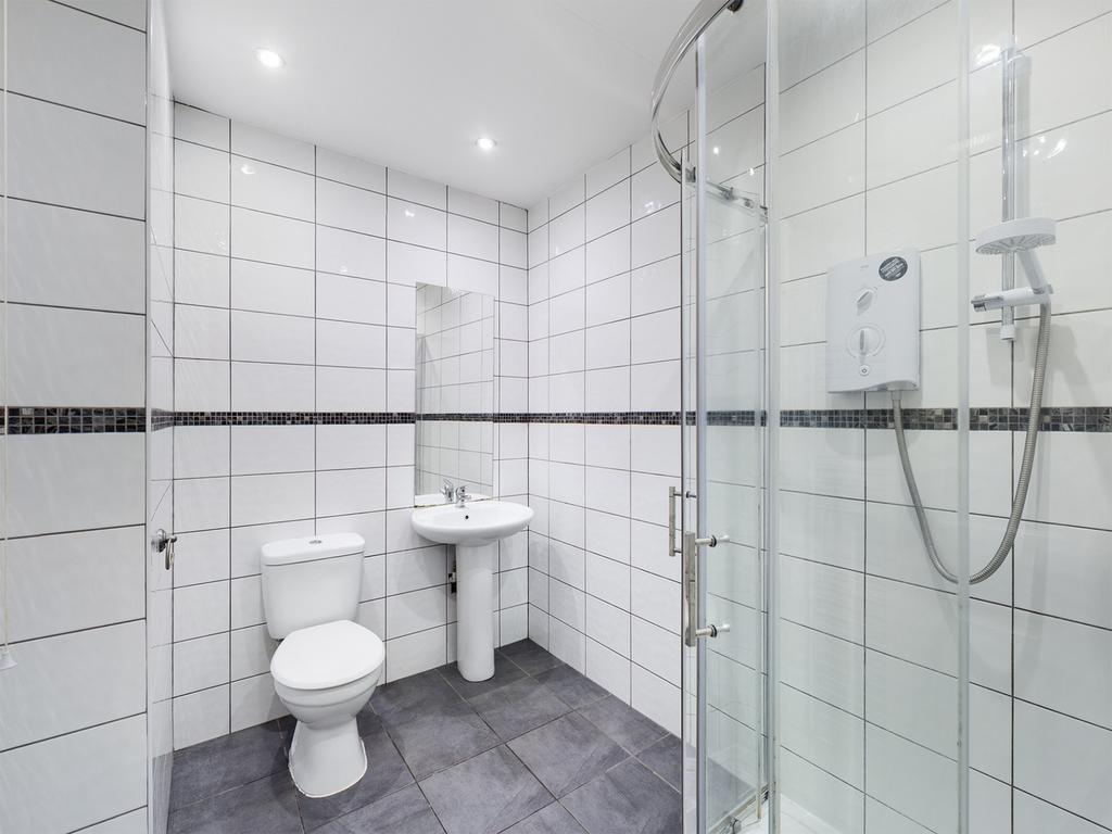 A modern and pristine bathroom featuring a spac...