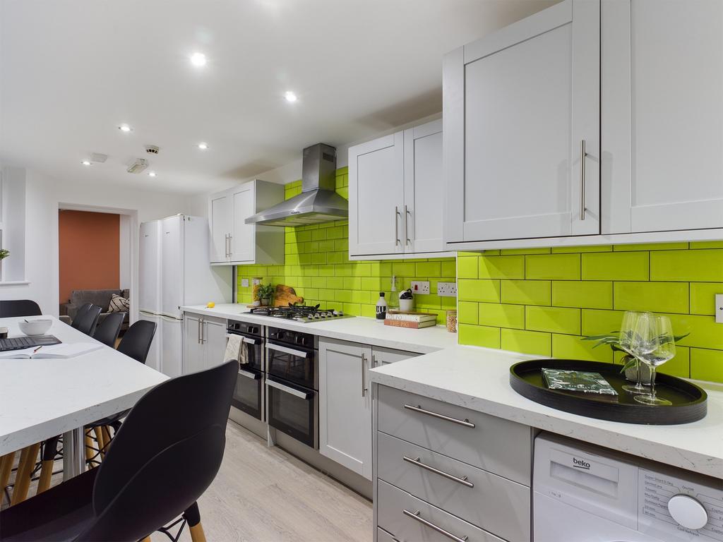 A modern and spacious kitchen featuring vibrant...