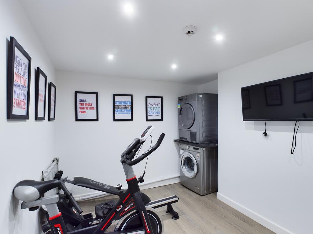 A bright and clean gym area with modern equipme...