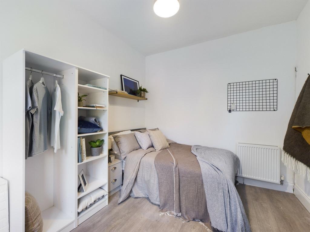 A bright and welcoming bedroom featuring a doub...