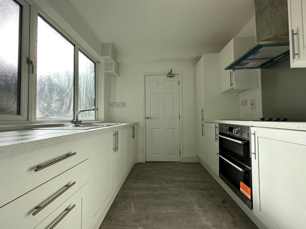 A bright and modern kitchen with ample natural ...