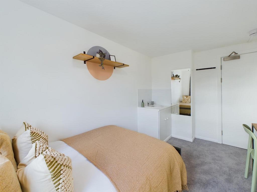 A bright and stylish double bedroom with modern...