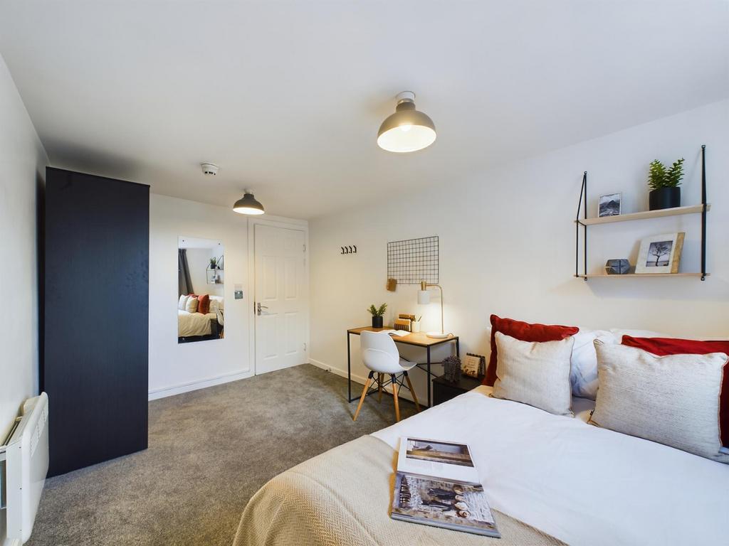 A spacious and inviting double bedroom featurin...