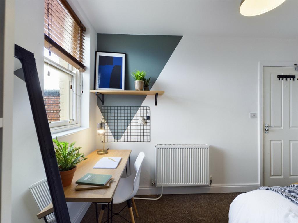 A bright and inviting double bedroom featuring ...