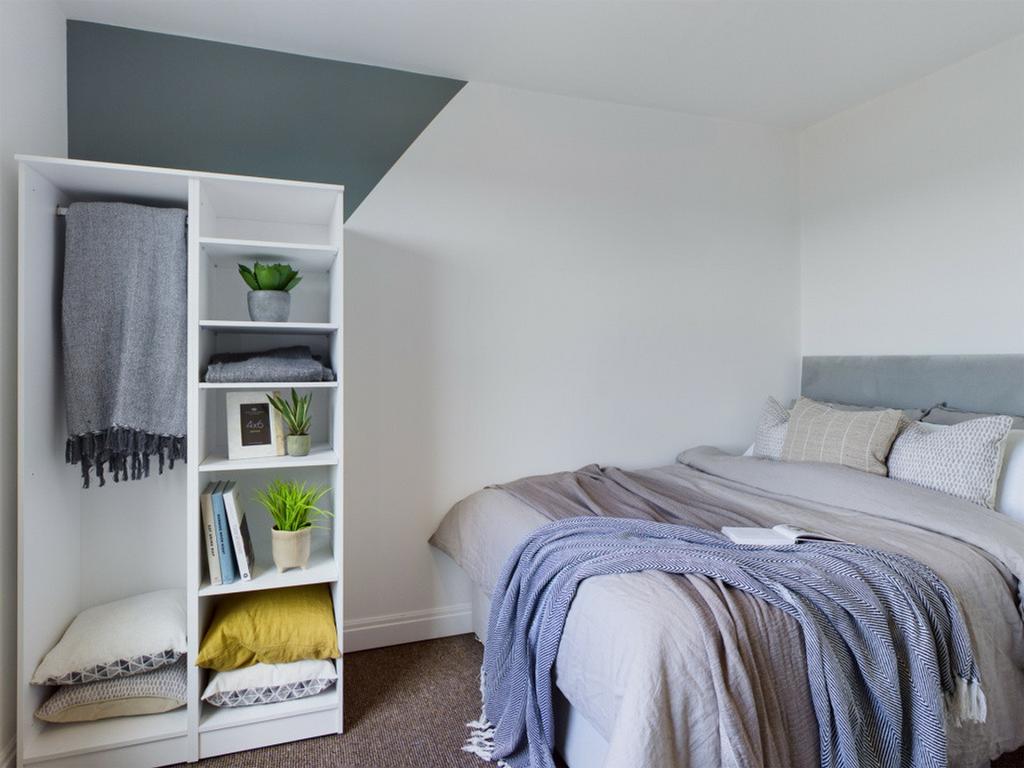 A beautifully arranged double bedroom with a co...