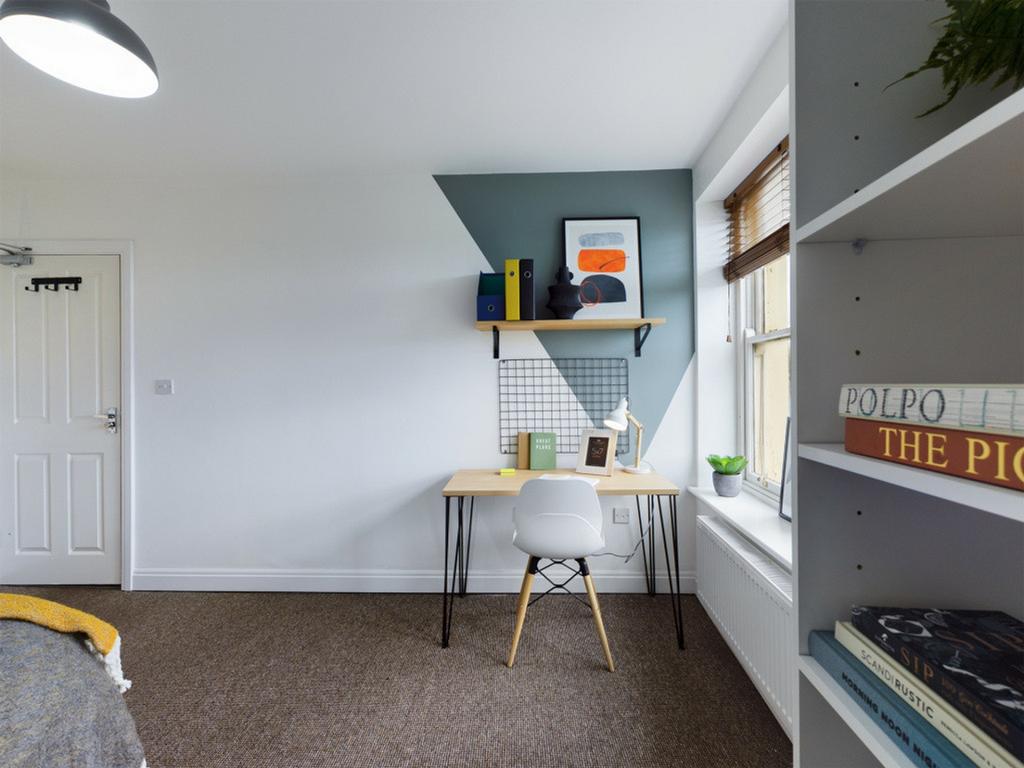 A bright and inviting double bedroom featuring ...