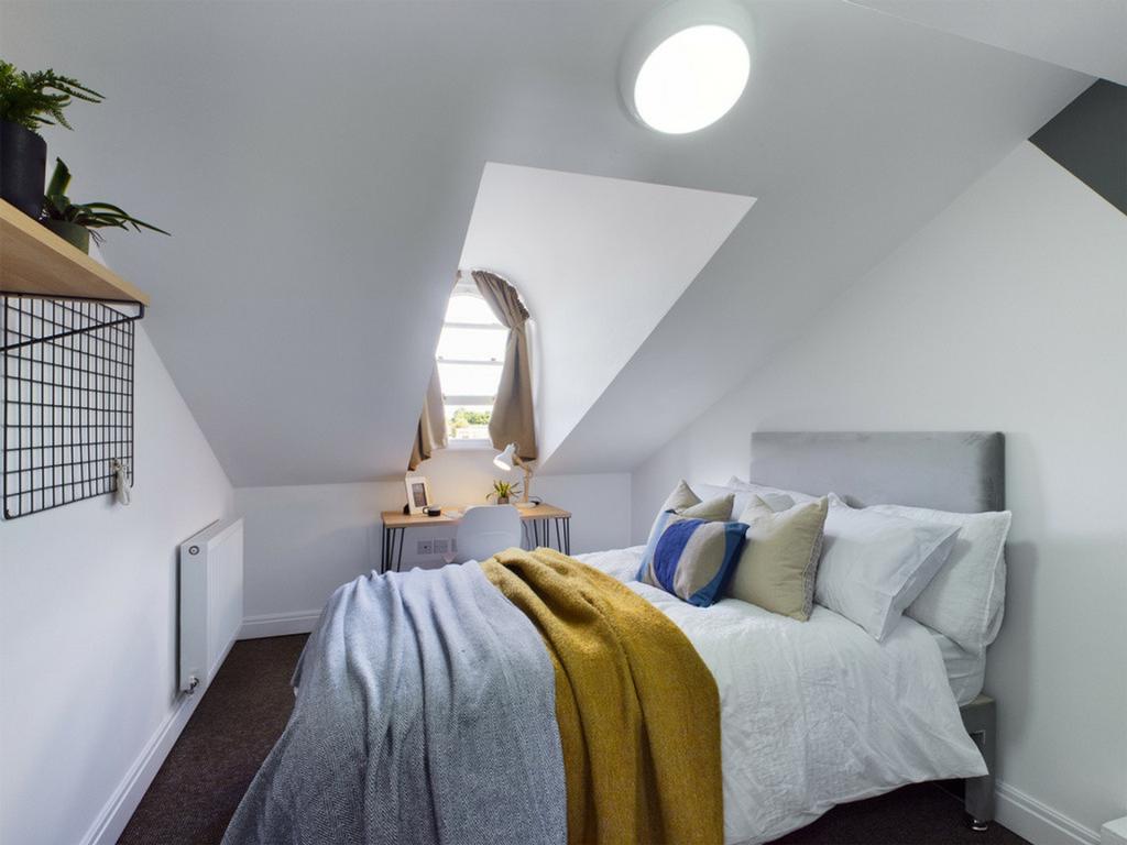 A bright and inviting double bedroom featuring ...